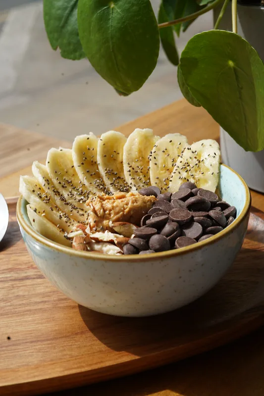 Banana bowl with peanut butter, chocolate and chia seeds