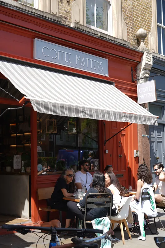 Coffee Matters storefront and outdoor tables on Bethnal Green Road